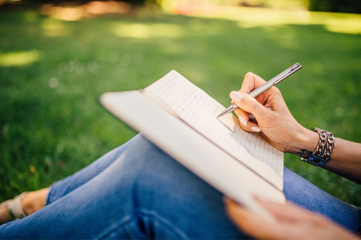 Woman writting down in a journal